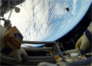 Illustration for article titled Beautiful Images of Astronauts Releasing Nanosatellites Into Space